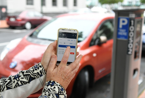 A person paying for parking using the AT Mobile app