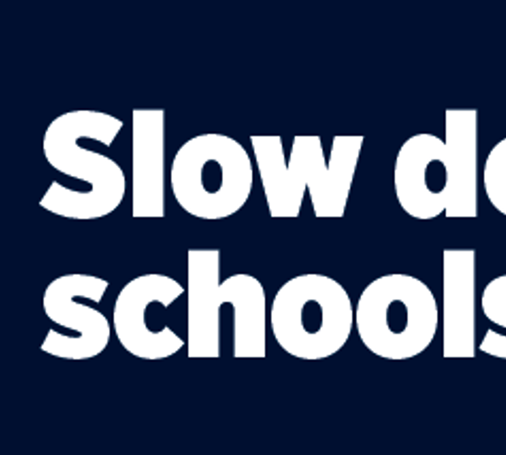 Image shows two children wearing a school uniform with the text saying: slow down around schools for us.