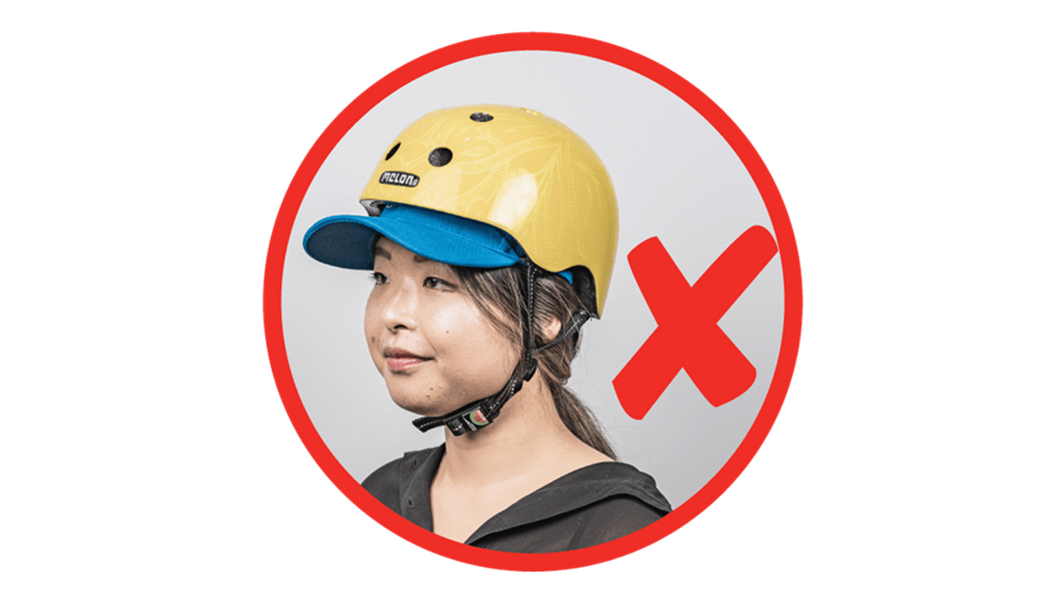 A woman wears a helmet with a cap underneath it.