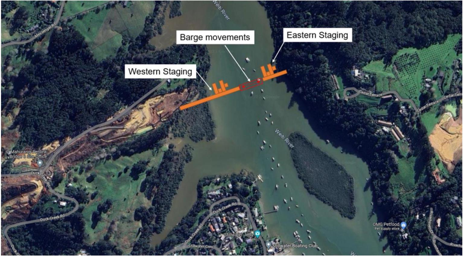 Aerial view of a river with barges operating between western and eastern staging areas.