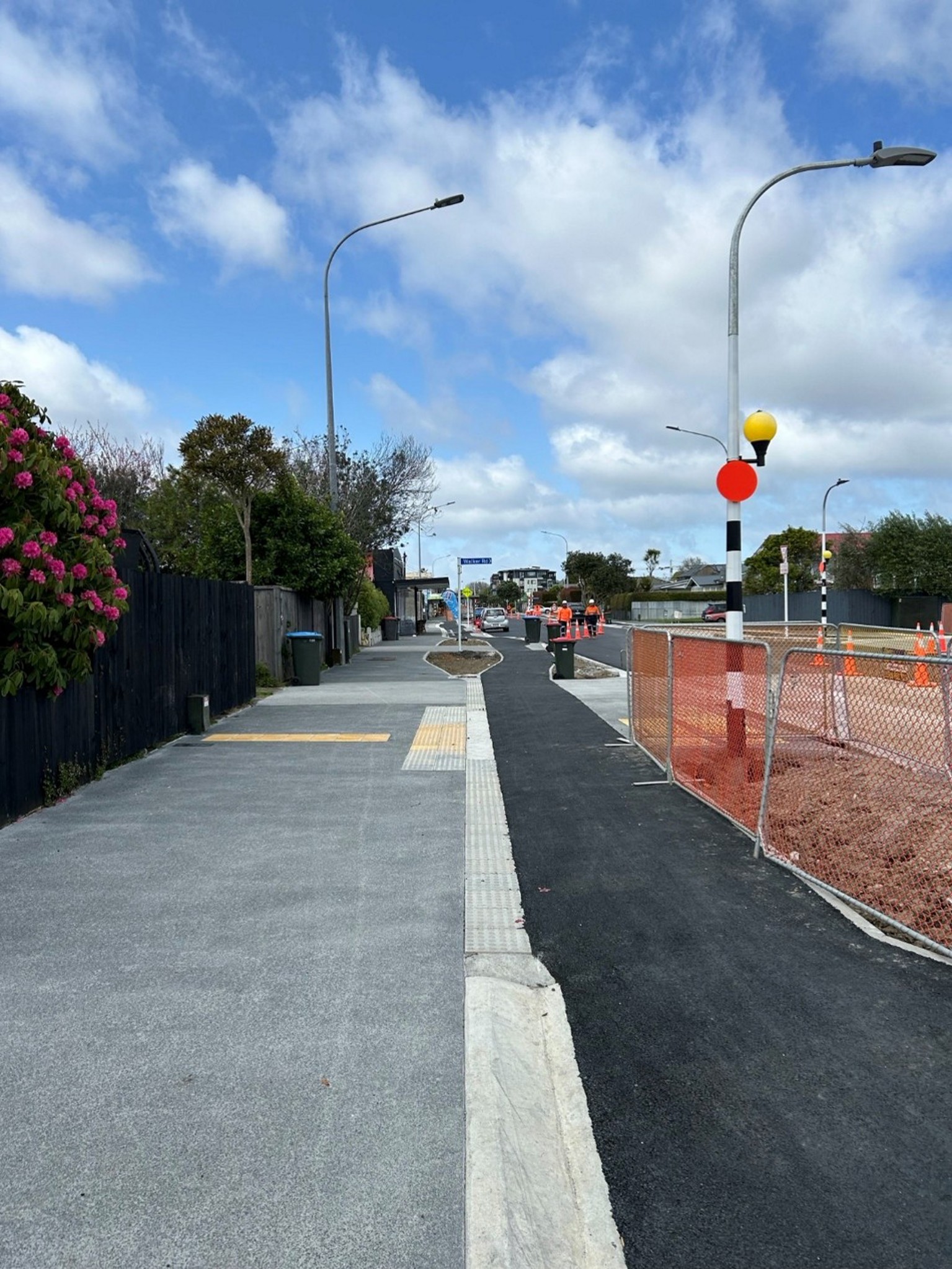 Low carbon concrete being laid on the road during the construction of the Point Chevalier to Westmere cycleway and footpath upgrades.