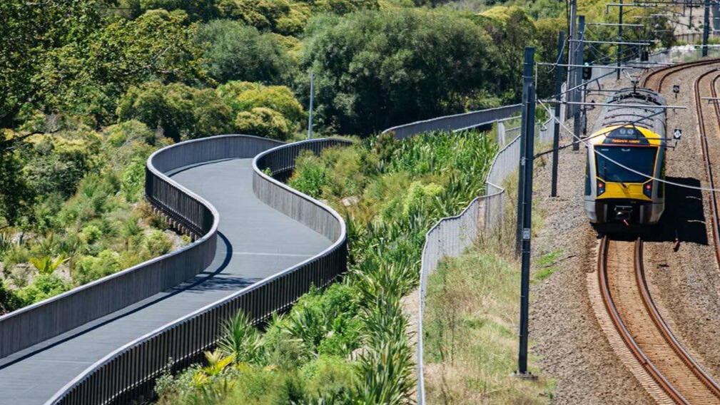 A raised walkway running alongside a train on a railway.