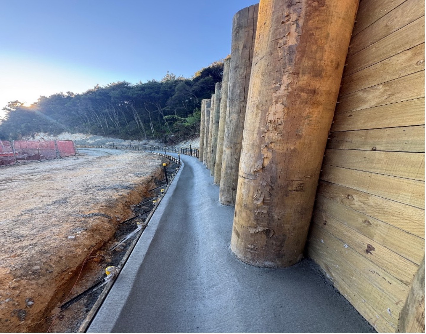 New concrete drainage below the new timber retaining wall.