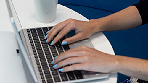 Hands typing on a keyboard