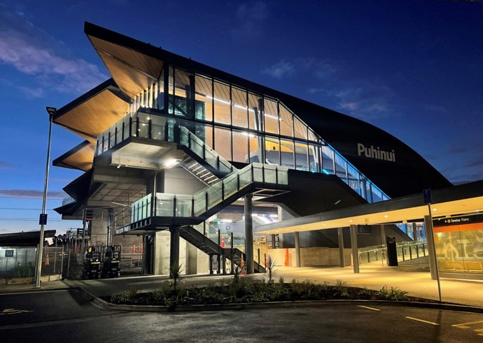 The exterior of Puhinui station at night.