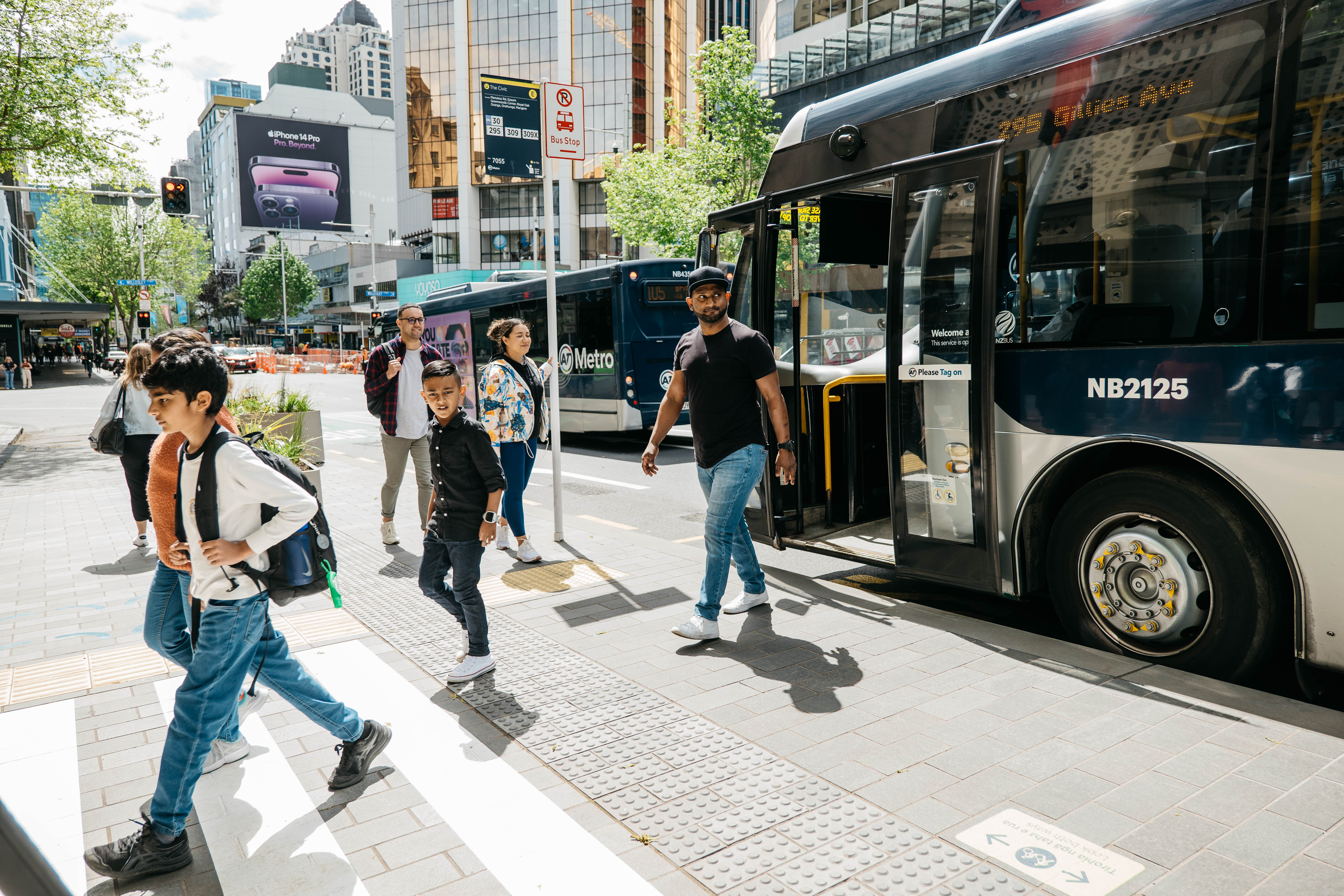 People boarding and leaving a bus