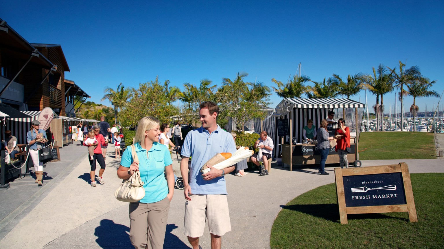 Couple walking at market in Pine Harbour.