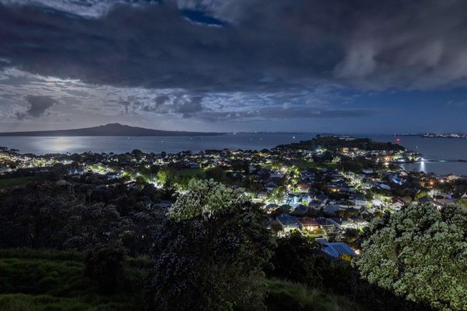 A photo of the lower North Shore at night after the streetlight upgrade. It is much darker and the streetlights are now whiter.